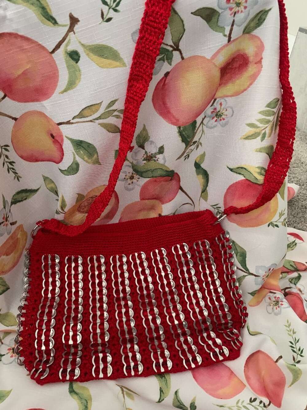 Vibrant Red Artisan Handbag with red shoulder straps and silver-color accents